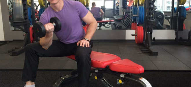 Concentrated bending of one hand with a dumbbell